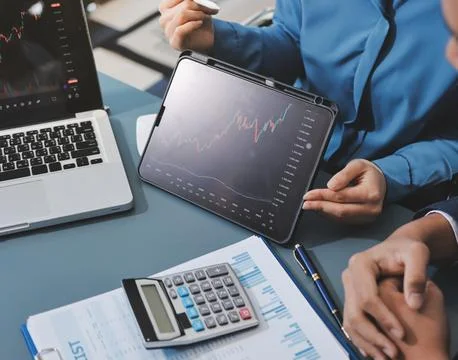 Business professional analyzing financial data on digital tablet dashboard .. Stock Photos