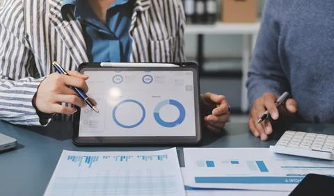 Business professional analyzing financial data on digital tablet dashboard .. Stock Photos