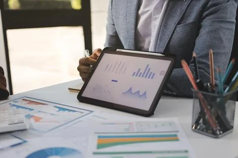 Business professional analyzing financial data on digital tablet dashboard .. Stock Photos