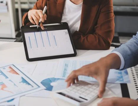 Business professional analyzing financial data on digital tablet dashboard .. Stock Photos