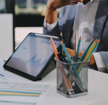Business professional analyzing financial data on digital tablet dashboard .. Stock Photos