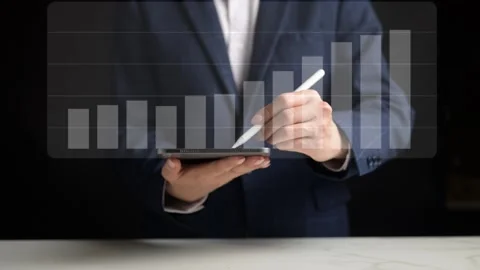 Business Professional Conducting Data Analysis with Tablet Device Office Setting Stock Footage 296569288