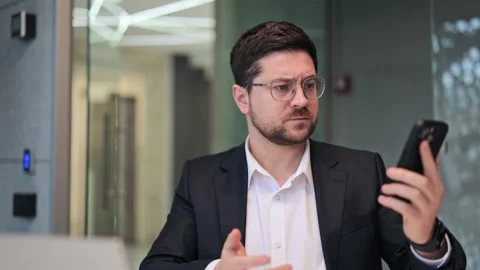 Business Professional Confused Using Smartphone Stock Footage 330155937