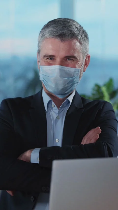A Business Professional Engaged in Remote Work While Wearing a Safety Mask for Stock Footage 313794585