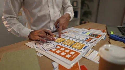 Business professional reviewing mobile application wireframes Stock Footage 343236765