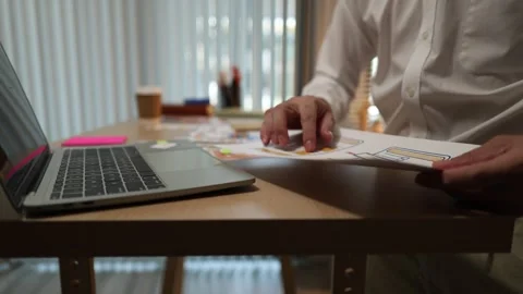 Business professional reviewing mobile application wireframes Stock Footage 343236932