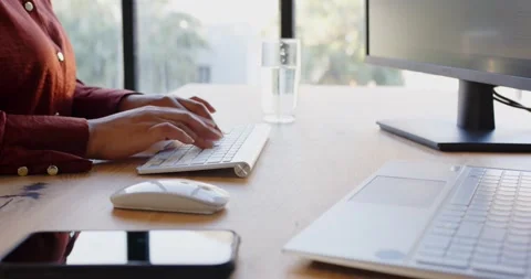 Business professional using computer mouse and keyboard at office desk 스톡 동영상 346285255