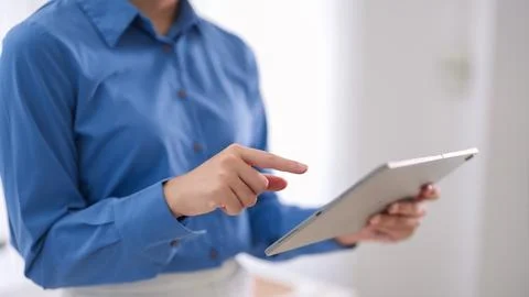 Business professional using digital tablet touchscreen technology reviewing.. Stock Photos