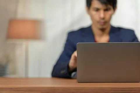 Business Professional Using Laptop Computer in Modern Office Environment Stock Photos