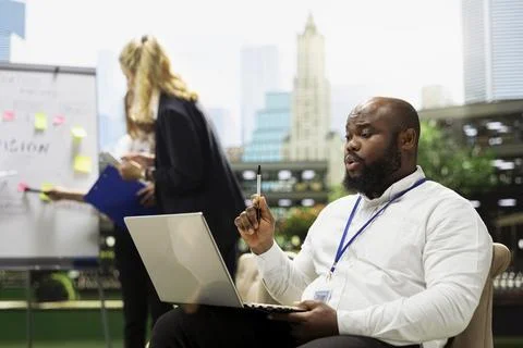 Business professional using laptop during outdoor strategy workshop Stock Photos