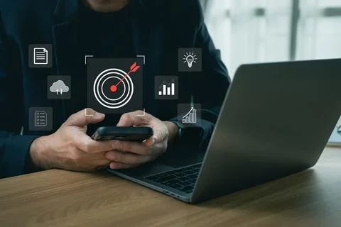 Business professional using smartphone with digital target and growth icons.. Stock Photos