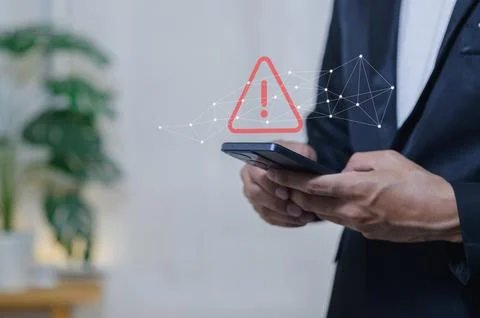 Business Professional Using Smartphone with Digital Warning Icon Overlay Stock Photos