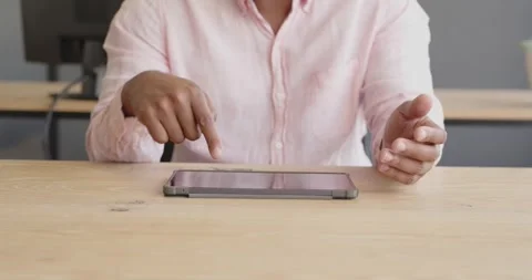Business professional using tablet at office desk, focusing on digital tasks Stock Footage 346145591