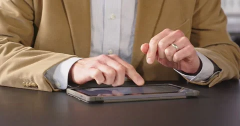 Business professional using tablet for work at office, focusing on task Stock Footage 346029081