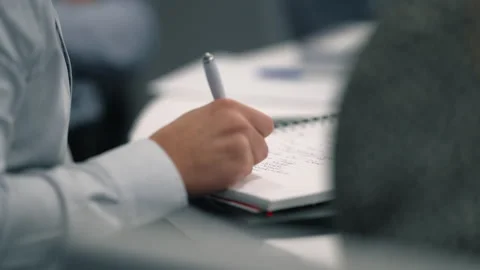 Business professional writing notes during team meeting Stock Footage 332211795