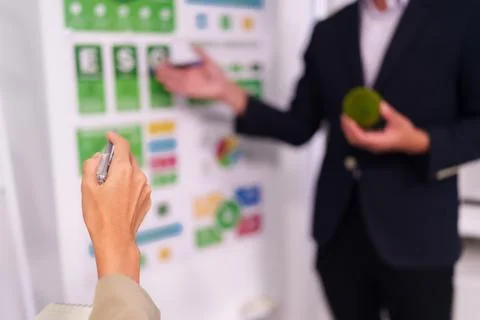 Business professionals analyzing ESG data discussing sustainable strategy d.. Foto stock