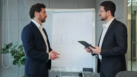 Business Professionals Discussing KPI Performance in Office Meeting Video stock 330155603