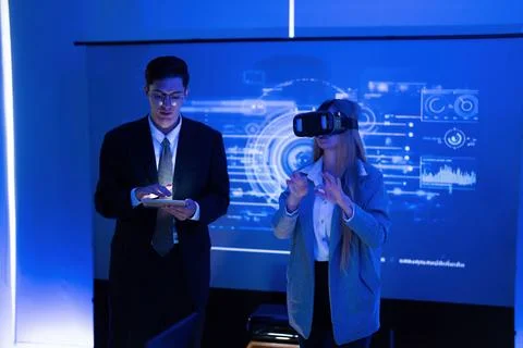 Business professionals explore virtual reality technology in a modern offic.. Stock Photos