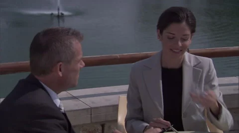 Business professionals sitting and talking at an outside cafe. Stock Footage 46867985
