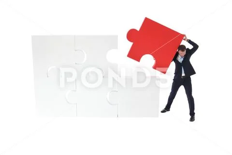 Business pushing the final piece of puzzle Stock Photos