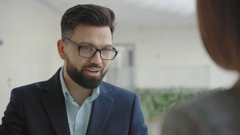 Business solid man with a beard says something to a woman. Video stock 107276350