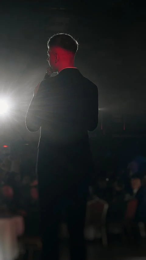 Business Speaker Standing on Stage in Front of Audience at Event. Stock Footage 345557803