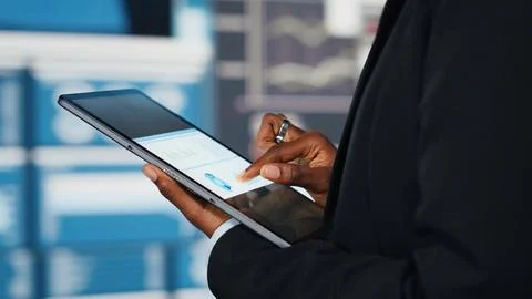 Business specialist using tablet to compare company KPIs data Stock Photos