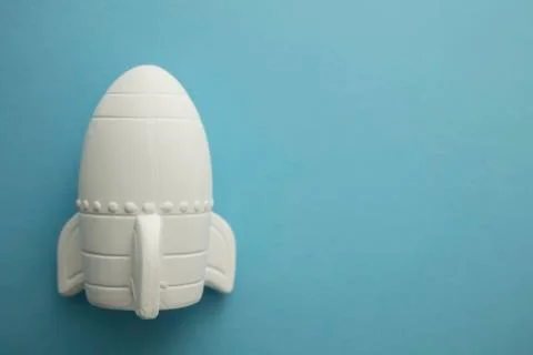Business startup concept. Rocket ship against a blue background Stock Photos