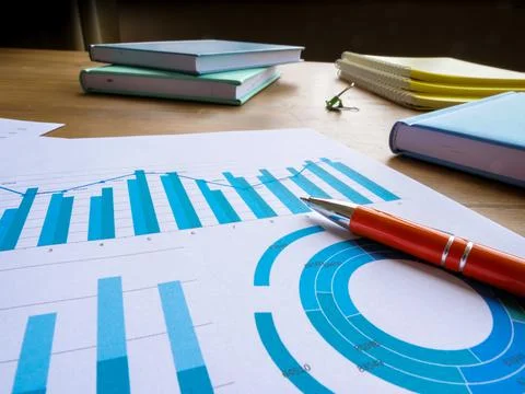 Business statistics and data analysis. Papers with financial results on the Stock Photos