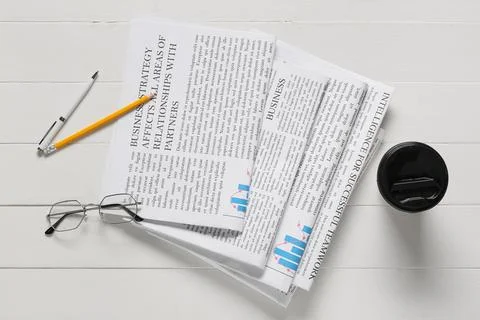 Business strategy documents with reading glasses, pen, pencil, and coffee cup Stock Photos