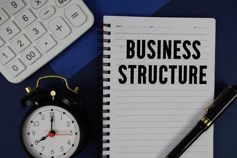 Business Structure text written on notepad with calculator and alarm clock .. Stock Photos