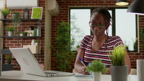 Business student taking notes at online webinar class on laptop Stock Footage 203854509
