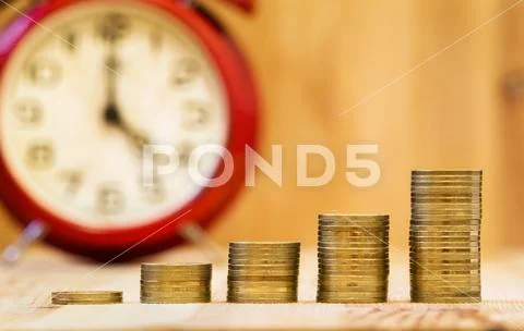 Business success - alarm clock and money coins Stock Photos