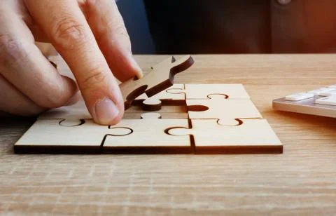 Business success and problem solving. Man holds piece of puzzle. Stock Photos
