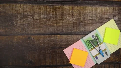 Business success concept with notes and 100 euro banknotes. Stop motion Stock Footage