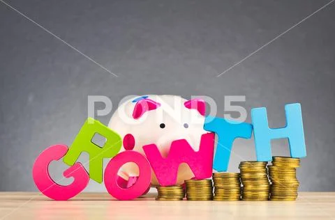 Business success concept, piggy bank, stacking coins and word GROWTH on woode Stock Photos