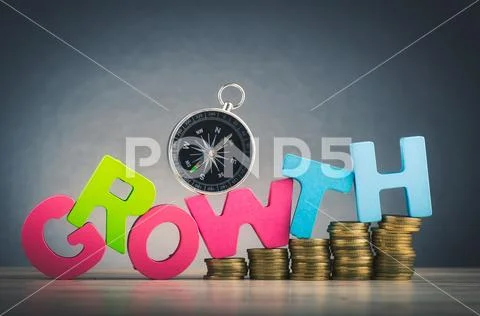 Business success concept, stacking coins and word GROWTH on wooden desk over Stock Photos
