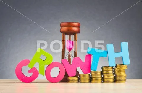Business success concept, stacking coins and word GROWTH on wooden desk over Stock Photos