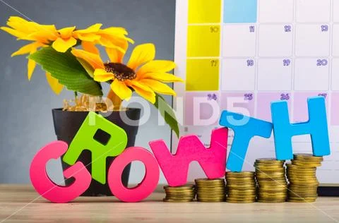 Business success concept, stacking coins and word GROWTH on wooden desk over Stock Photos
