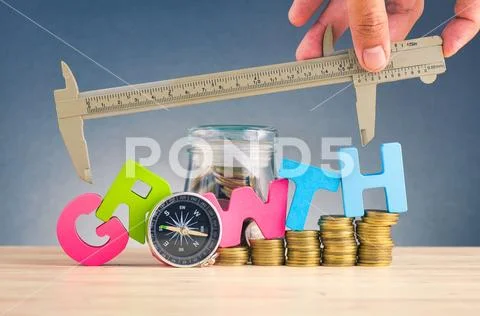 Business success concept, stacking coins and word GROWTH on wooden desk over Stock Photos
