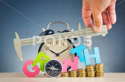 Business success concept, stacking coins and word GROWTH on wooden desk over Stock Photos