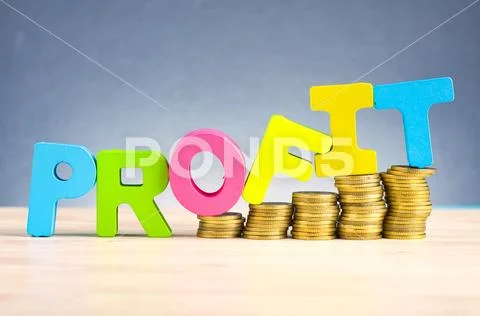 Business success concept, stacking coins and word PROFIT on wooden desk over Stock Photos