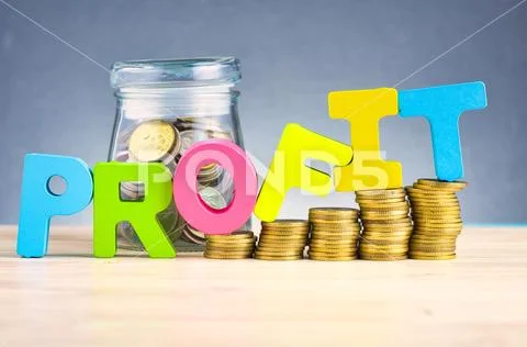 Business success concept, stacking coins and word PROFIT on wooden desk over Stock Photos