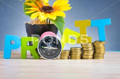 Business success concept, stacking coins and word PROFIT on wooden desk over Stock Photos
