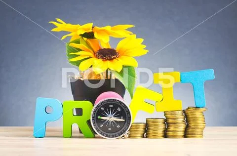 Business success concept, stacking coins and word PROFIT on wooden desk over Stock Photos