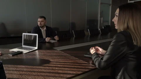 Business talking two men and woman round the black table by a large window. Stock Footage 125124372