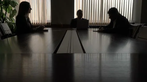 Business talking two men and woman round the black table by a large window Video stock 133397433