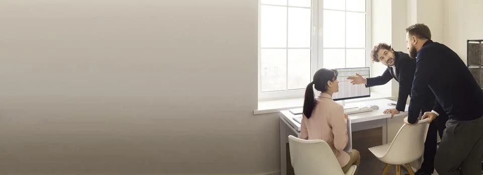 Business team analyzing dashboard data on computer in modern office, wide frame Stock Photos