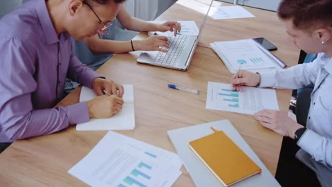 Business team analyzing data and brainstorming in a meeting Stock Footage 339608855