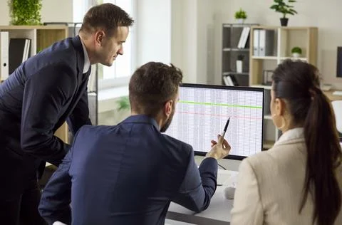 Business team analyzing data on computer, planning strategy and tasks in office Foto stock